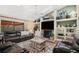 Inviting living room features a fireplace, built-in shelving, and a sliding glass door to the screened patio at 1004 Hollyberry Ct, Brandon, FL 33511