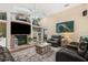 Cozy living room with a fireplace, hardwood floors, comfortable seating, and natural light at 1004 Hollyberry Ct, Brandon, FL 33511