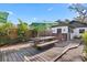 Outdoor dining area featuring a wooden deck, picnic table, and an outdoor kitchen, perfect for entertaining at 1004 Hollyberry Ct, Brandon, FL 33511