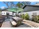 Outdoor entertaining space with a wooden deck, picnic table, patio area, and an outdoor kitchen at 1004 Hollyberry Ct, Brandon, FL 33511