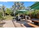 Outdoor dining and kitchen area, with palm trees and covered grills at 1004 Hollyberry Ct, Brandon, FL 33511