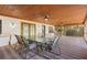 Large covered patio with brick flooring, seating for six and ceiling fans for comfort at 1004 Hollyberry Ct, Brandon, FL 33511