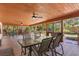 Spacious outdoor patio with ceiling fans, table seating, and views to the backyard at 1004 Hollyberry Ct, Brandon, FL 33511