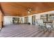Large outdoor patio with wood paneled ceilings, ceiling fans, and tables at 1004 Hollyberry Ct, Brandon, FL 33511
