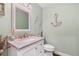 Stylish half bath with a granite countertop vanity, neutral paint, and decorative nautical accents at 1004 Hollyberry Ct, Brandon, FL 33511