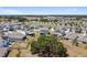 Aerial view of a neighborhood with lakes, an oak tree, and many single-Gathering homes at 10749 Tally Fawn Loop, San Antonio, FL 33576