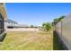 Spacious backyard with well-maintained lawn and white fence at 10749 Tally Fawn Loop, San Antonio, FL 33576