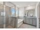 Bathroom with bathtub and separate glass enclosed shower with granite countertops at 10749 Tally Fawn Loop, San Antonio, FL 33576