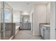 Bathroom with bathtub and separate glass enclosed shower, granite countertops, and double sinks at 10749 Tally Fawn Loop, San Antonio, FL 33576