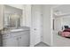 Well-lit bathroom offers a granite vanity countertop and a glass-enclosed shower at 10749 Tally Fawn Loop, San Antonio, FL 33576