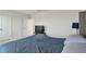 Bedroom with carpeted floors featuring a television and a comfortable queen size bed with pillows at 10749 Tally Fawn Loop, San Antonio, FL 33576