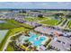 An aerial view of the community pool and recreation center, surrounded by lush landscaping at 10749 Tally Fawn Loop, San Antonio, FL 33576
