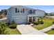 Charming two-story home featuring a manicured lawn, elegant stone accents, and an attached two-car garage at 10749 Tally Fawn Loop, San Antonio, FL 33576