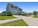 Charming two-story home featuring a manicured lawn, elegant stone accents, and an attached two-car garage at 10749 Tally Fawn Loop, San Antonio, FL 33576