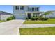 Charming two-story home featuring a manicured lawn, elegant stone accents, and an attached two-car garage at 10749 Tally Fawn Loop, San Antonio, FL 33576