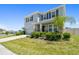 Charming two-story home featuring a manicured lawn, elegant stone accents, and an attached two-car garage at 10749 Tally Fawn Loop, San Antonio, FL 33576