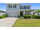 Charming two-story home featuring a manicured lawn, elegant stone accents, and an attached two-car garage at 10749 Tally Fawn Loop, San Antonio, FL 33576