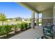 Inviting front porch featuring stone pillars and charming seating, perfect for relaxing outdoors at 10749 Tally Fawn Loop, San Antonio, FL 33576