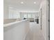 Hallway leading to living space with natural light and neutral tones at 10749 Tally Fawn Loop, San Antonio, FL 33576