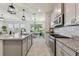Modern kitchen showcasing granite countertops, stainless steel appliances, and an open layout concept at 10749 Tally Fawn Loop, San Antonio, FL 33576