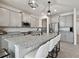 Modern kitchen boasting a large island with seating, granite countertops, and stainless steel appliances at 10749 Tally Fawn Loop, San Antonio, FL 33576