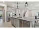 Modern kitchen featuring stainless steel appliances, granite countertops, an island, and an open floor plan at 10749 Tally Fawn Loop, San Antonio, FL 33576