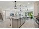 A spacious kitchen island anchors the open-concept layout, seamlessly connecting the living and dining areas at 10749 Tally Fawn Loop, San Antonio, FL 33576