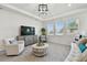 Bright living room features recessed lighting, three large windows, and neutral decor at 10749 Tally Fawn Loop, San Antonio, FL 33576
