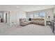 A room with large sofa, carpeted floor, and multiple windows at 10749 Tally Fawn Loop, San Antonio, FL 33576