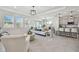 Bright open living space featuring tile flooring, neutral tones, and a modern kitchen with bar seating at 10749 Tally Fawn Loop, San Antonio, FL 33576