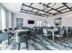 Spacious community room featuring a custom ceiling, pendant lighting, and multiple tables and chairs at 10749 Tally Fawn Loop, San Antonio, FL 33576