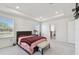Primary bedroom features tray ceiling, carpet, and adjoining bathroom at 10749 Tally Fawn Loop, San Antonio, FL 33576