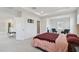 Bedroom featuring tray ceiling, carpet, and sitting room at 10749 Tally Fawn Loop, San Antonio, FL 33576