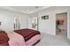 Main bedroom featuring tray ceiling, carpet, walk-in closet, and an adjoining sitting room at 10749 Tally Fawn Loop, San Antonio, FL 33576