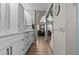 Bathroom featuring modern white cabinetry and a long vanity, offering ample storage and a sleek design at 1077 Captains Way, Tarpon Springs, FL 34689