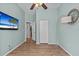 Bedroom with wood floor, ceiling fan, and closet, filled with natural light at 1077 Captains Way, Tarpon Springs, FL 34689