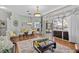 Elegant dining area with stylish chandelier and seamless access to the outdoor screened-in lanai at 1077 Captains Way, Tarpon Springs, FL 34689