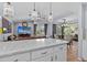 Gourmet kitchen featuring a spacious island, modern pendant lighting, and an open concept to the living spaces at 1077 Captains Way, Tarpon Springs, FL 34689