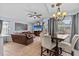Inviting living room and dining area featuring neutral colors, tile floors, and lots of natural light at 1077 Captains Way, Tarpon Springs, FL 34689