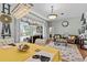 Open-concept living space features hardwood floors, elegant chandeliers, and backyard pool access at 1077 Captains Way, Tarpon Springs, FL 34689