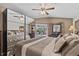 This is a charming main bedroom with beautiful wallpaper, a large bed, and access to an outdoor pool area at 1077 Captains Way, Tarpon Springs, FL 34689