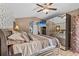 Spacious main bedroom has a television, walk in closet, and a connecting door to the main bathroom at 1077 Captains Way, Tarpon Springs, FL 34689