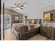 This is a charming main bedroom with beautiful wallpaper, a large bed, and access to an outdoor pool area at 1077 Captains Way, Tarpon Springs, FL 34689