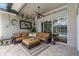 Covered patio with comfortable wicker furniture and a view of the pool area at 1077 Captains Way, Tarpon Springs, FL 34689