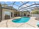 Sparkling pool with pavers, seating, and a view of the home's exterior at 1077 Captains Way, Tarpon Springs, FL 34689