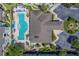 An aerial view of a community pool, the building and a parking lot at 1240 S Missouri Ave # 415, Clearwater, FL 33756