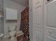 Cozy bathroom featuring a shower with colorful curtain and functional cabinet storage at 1240 S Missouri Ave # 415, Clearwater, FL 33756