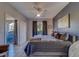 Bright bedroom with window, patio access, stylish decor and comfortable bed with ceiling fan at 1240 S Missouri Ave # 415, Clearwater, FL 33756