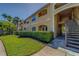 Attractive exterior of a multi-unit building with lush green landscaping and staircase at 1240 S Missouri Ave # 415, Clearwater, FL 33756