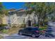 Two-story condo building featuring a car parked in the parking lot at 1240 S Missouri Ave # 415, Clearwater, FL 33756